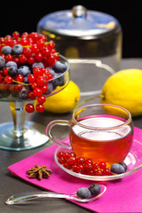 red fruits tea over black background