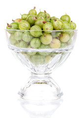 Green gooseberry in glass isolated on white