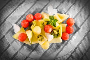 Fresh fruits salad on a glass plate. - Powered by Adobe