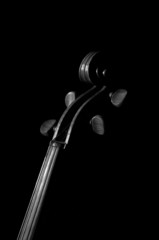 A black and white violin detail against a black back ground.