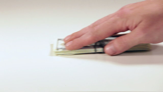 One hand gives money to another hand, close up