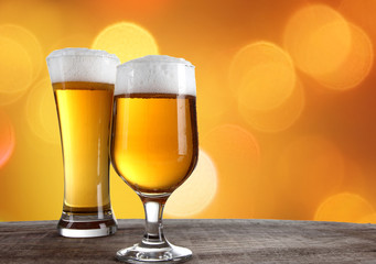 Beer in a glasses with gold background