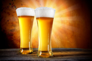Beer in a glasses with gold background