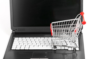 Online shopping. trolley on laptop