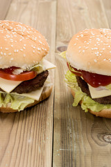 Two Cheeseburger on wooden background