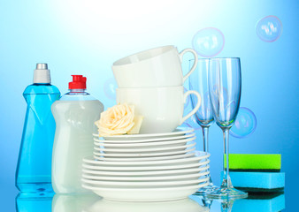 empty clean plates, glasses and cups with dishwashing liquid