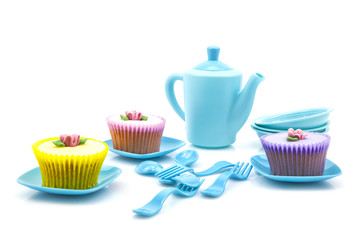 Tea party with cupcakes on white background