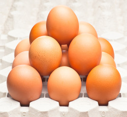 group of dark chicken eggs stacked in pyramid