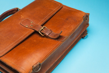 Brown Vintage leather briefcase on bright blue background