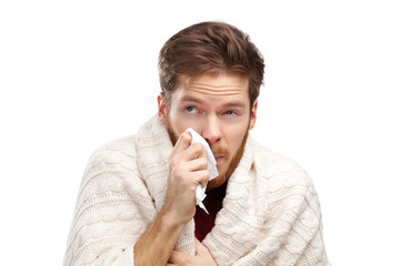 Sick young man holding wipes in his hands, isolated on white