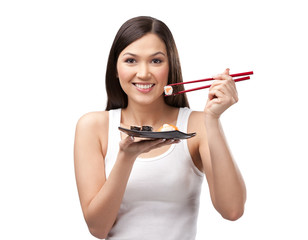 Fototapeta premium Beautiful girl holding sushi with a chopsticks, isolated