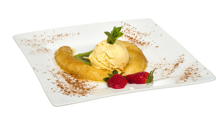 Dessert of banana, ice-cream, caramel, strawberry and mint