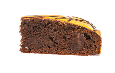 Piece of chocolate cake with icing on white isolated background