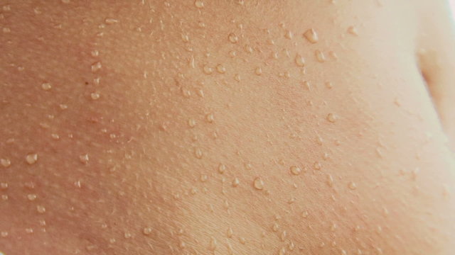 Water drops rolling down a girl's back