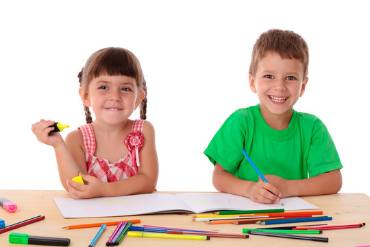 Two little kids draw with crayons