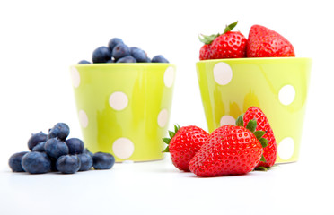Assorted fresh picked berries in a green mug