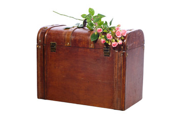 Beautiful pink roses bouquet lying on a vintage wooden trunk