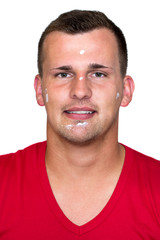 Fototapeta premium Young white man with moisturizer cream in his face