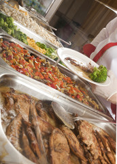 chef standing behind full lunch service station 