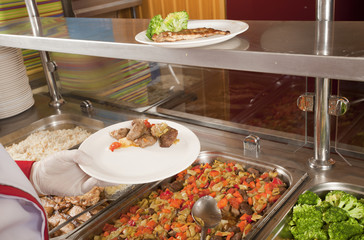 chef standing behind full lunch service station 