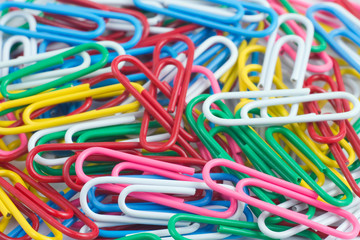 Colorful paper clip on white background close up