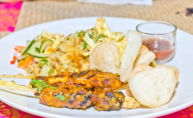 chicken satay on skewers and rice