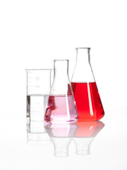 Clear liquid mixed with a red colored chemical reagent, isolated