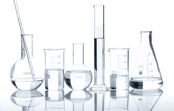 Group of laboratory flasks with a clear liquid, isolated