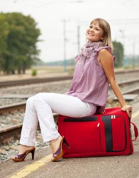 woman with luggage waiting  train