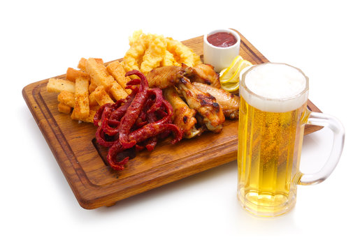 Closeup of spicy appetizer and glass of beer isolated