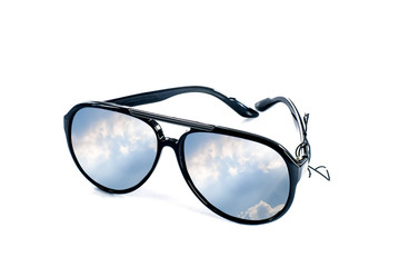 Sunglasses with blue sky shining ray reflection