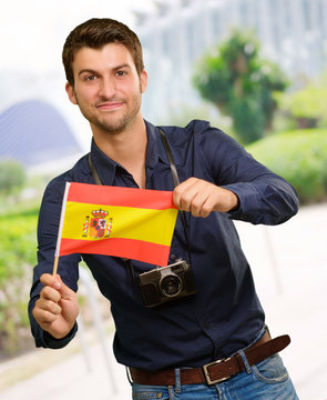 Portrait of a young man holding a flag