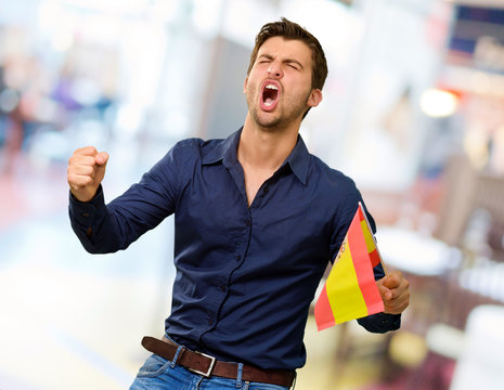 Man cheering and holding flag