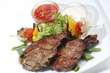 piece of meat fried with vegetables and sauce