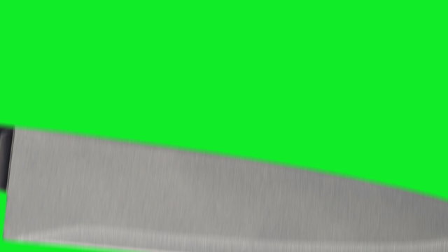 Knife stabbing at item of screen on green screen.