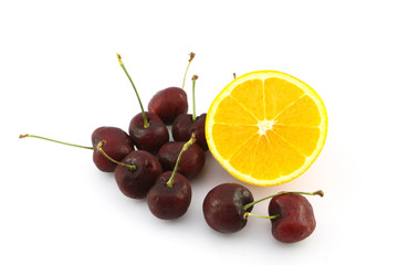 Half navel orange and cherry on white background