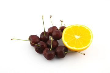 Navel orange and cherry on white background