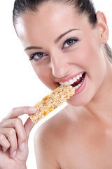Woman biting cereal bar