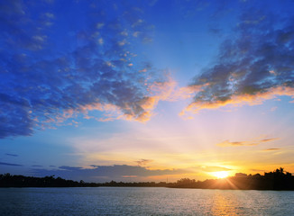 The picturesque colorful sunset into the sea