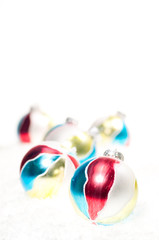 Hand painted Christmas  baubles on snow