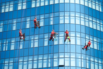Workers washing windows in the office building