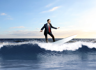Young business person surfing on the waves - obrazy, fototapety, plakaty