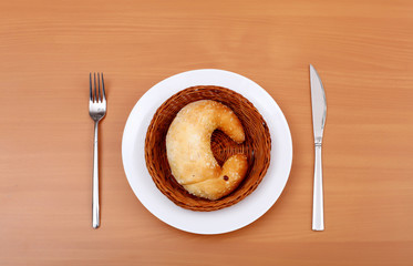 Fresh crossant on white plate