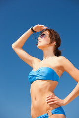 happy woman in sunglasses on the beach