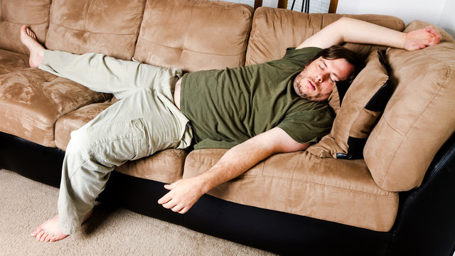 A guy flung all over the couch