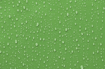 Fototapeta na wymiar Water Droplets on Green Metallic Surface