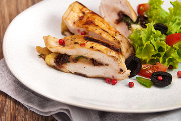 grilled chicken stuffed with mozzarella and sun-dried tomatoes - obrazy, fototapety, plakaty