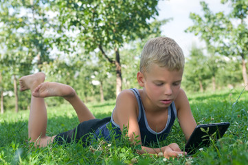 Boy playing in the tablet PC