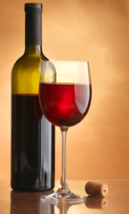 A glass of wine and a bottle