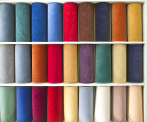 colorful carpets samples on the shelves